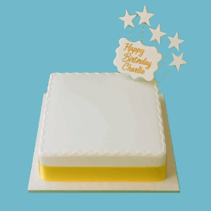 A square white fondant cake with a central space for a custom photo, bordered by a gold ribbon around the base. Gold star toppers decorate the top, and a small message plaque sits beside the photo area. The cake has a clean, elegant design suitable for various celebrations, offering options for size, flavour, and personalised messages.